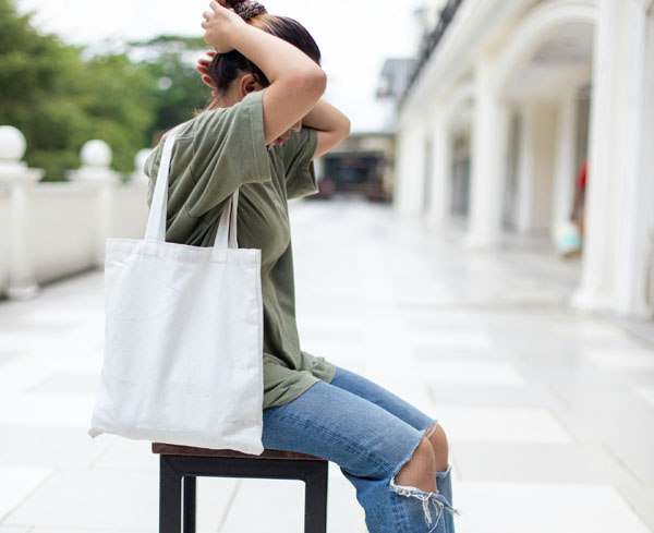 A girl carrying Canvas tote bags