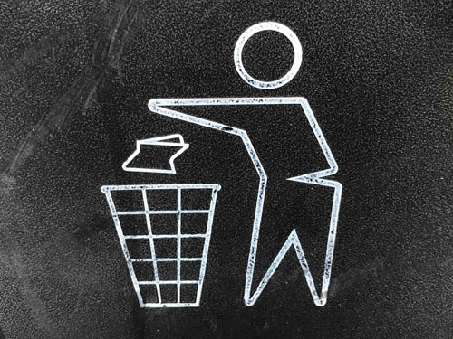 a stick-figure person handling junk removal jobs by throwing trash into a wireframe-style trash can.