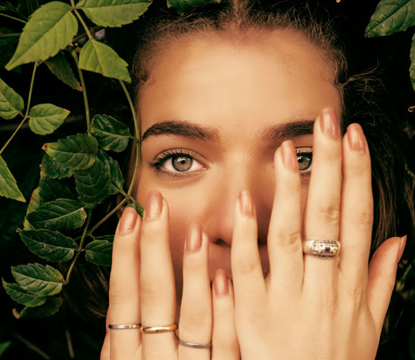 Pedi tools being used by a woman with rings covering her face.